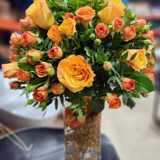 Orange flowers in glass bottle