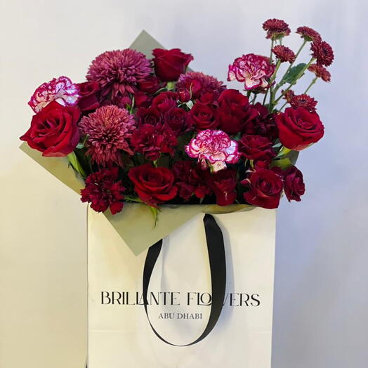 Букет из микса красных цветов в сумке