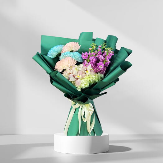Flamingo – 2 White Hydrangeas, 5 Lilies, 5 Pink Delphiniums, 3 Blue   3 Pink Chrysanthemums in Emerald Green Wrap