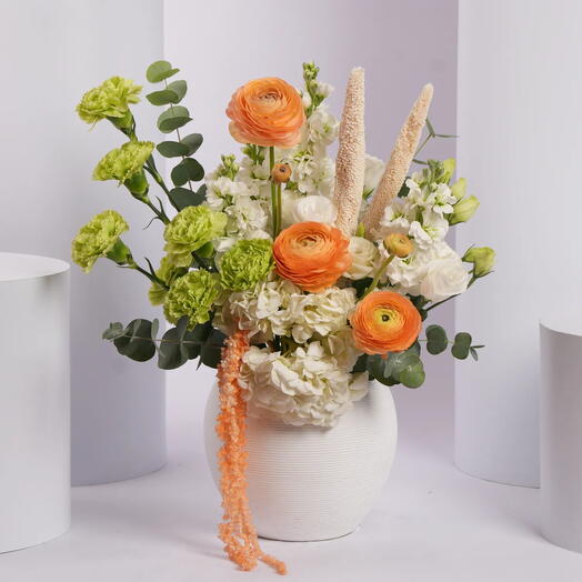Vibrant Orange and Green Flower Arrangement in White Vase