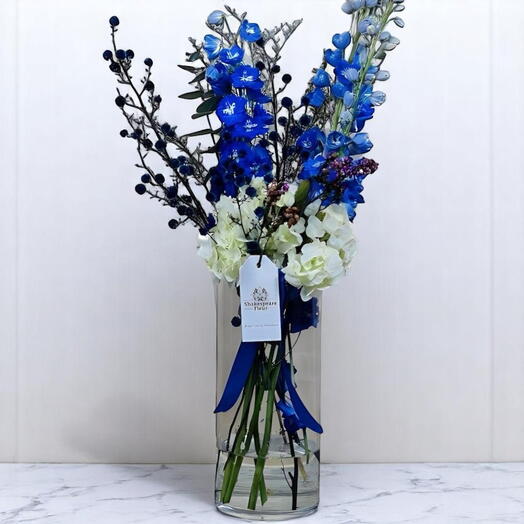 Elegant Blue and White Floral Arrangement in Glass Vase – Delphinium, Hydrangea   Hypericum