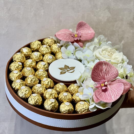 Choclates in premium leather tray with artificial flowers