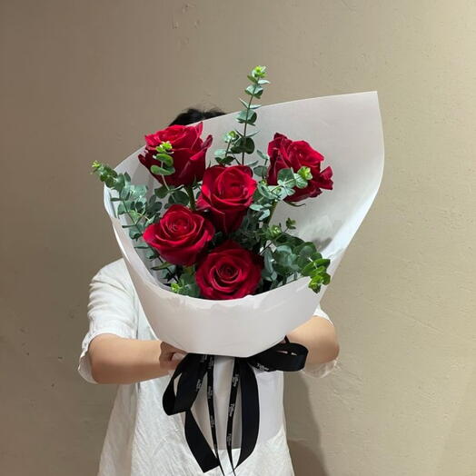 وردة حمراء ملفوفة بغلاف أبيض