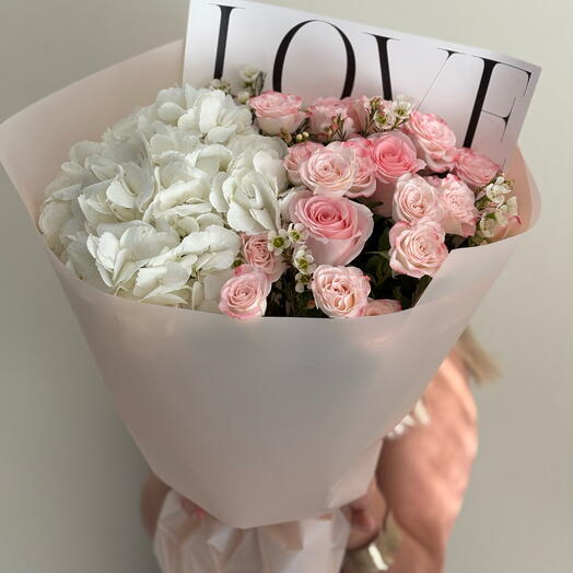 A bouquet of white hydrangeas and pink bush roses
