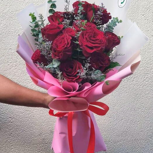 Red roses bouquet with a toy
