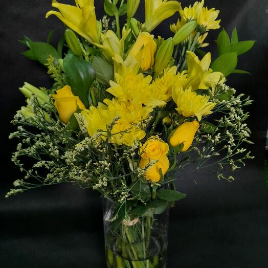 Yellow flowers in glass jar