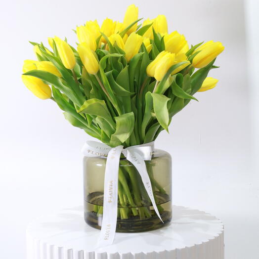 Yellow tulips in cylinder vase