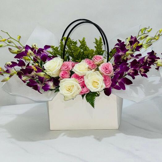Orchids with Roses nicely wrapped in a White bag;