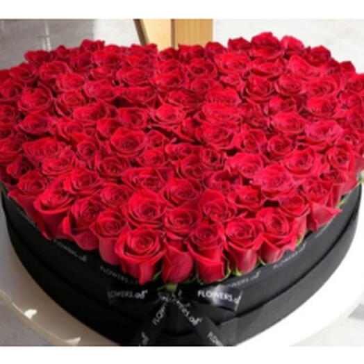 100 roses rouges sur une boîte noire en forme de cœur