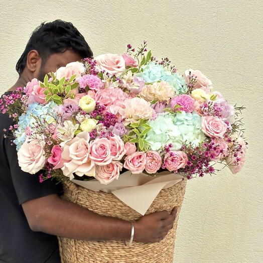 Bascket with piony roses and hydrangeas