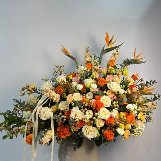 Vibrant orange roses and seasonal blooms