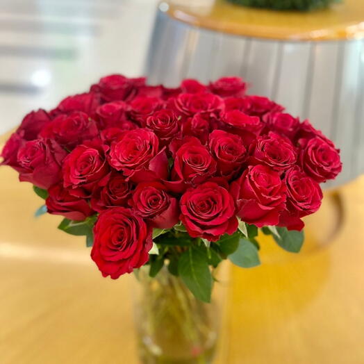 50 red roses in glass vase