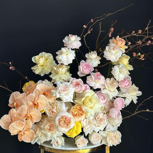 Bouquet of assorted peony roses and orchids in a hat box