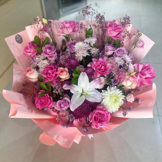 Mixed roses bouquet with chrysanthemums and pink gypsophila and ruscus