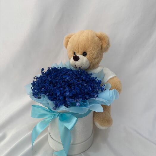 Boîte à fleurs avec ours en peluche bleu portant un texte imprimé