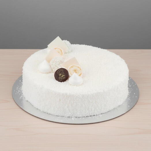 Coconut Snowfall Vanilla Cake — 1 kg White‑Chocolate Cream   Raffaello Topping | Serves 8‑10 | Tropical Luxe Dessert